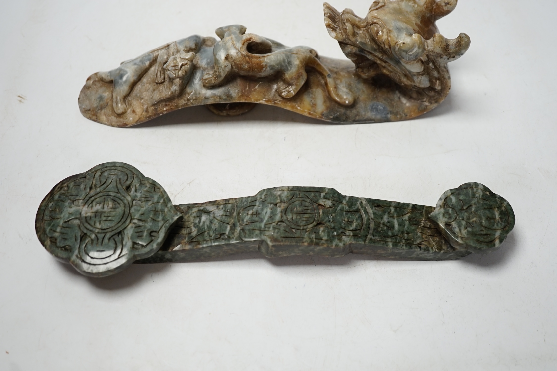 Two Chinese hardstone ruyi sceptres, one carved as a dragon, longest 30cm. Condition - fair